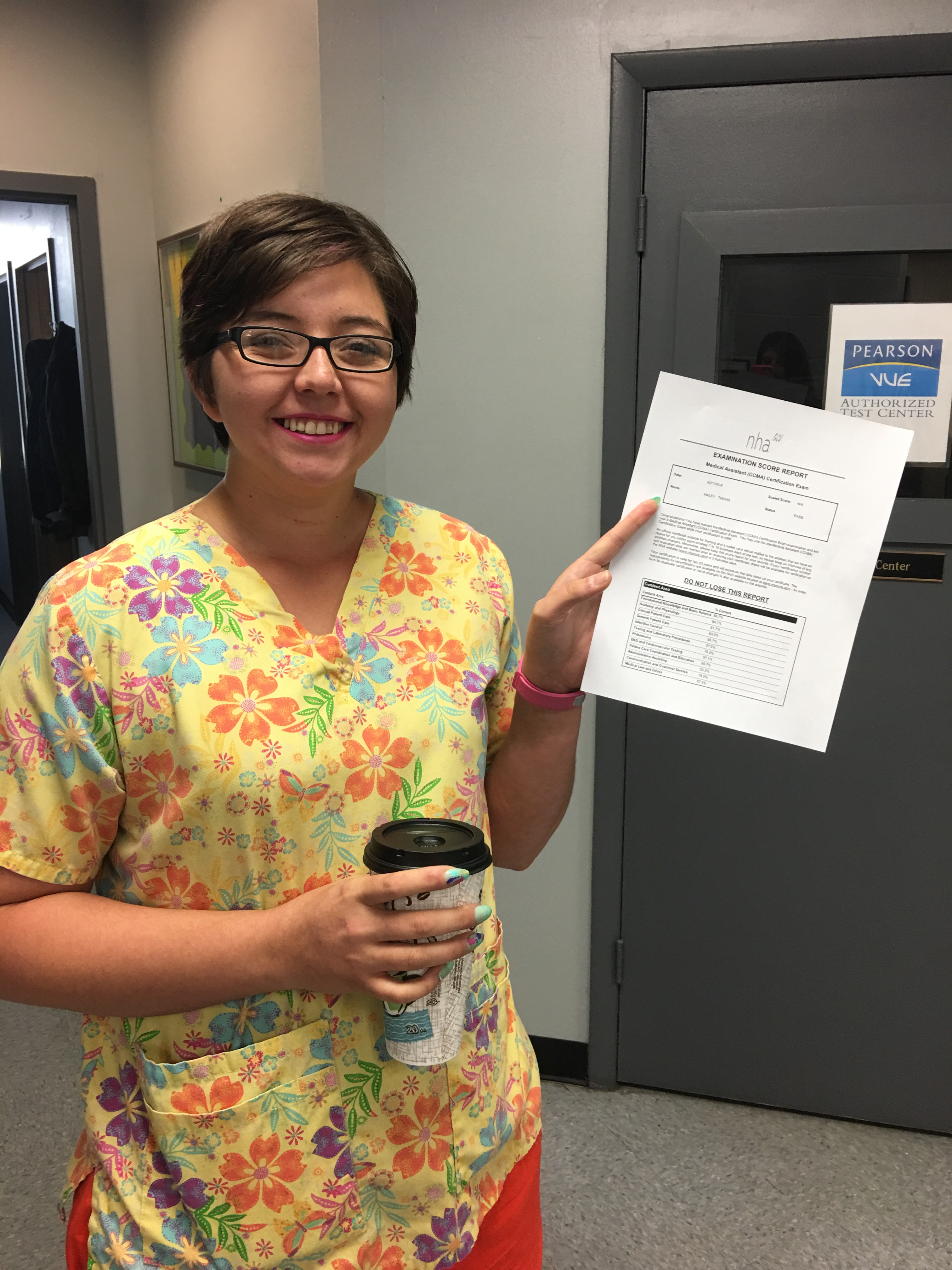 student in scrubs holding paper